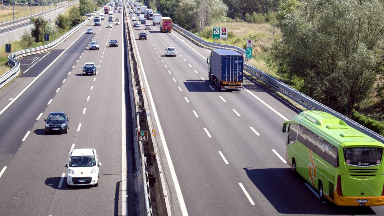 Φορτηγό, πούλμαν και επιβατικά οχήματα σε αυτοκινητόδρομο.